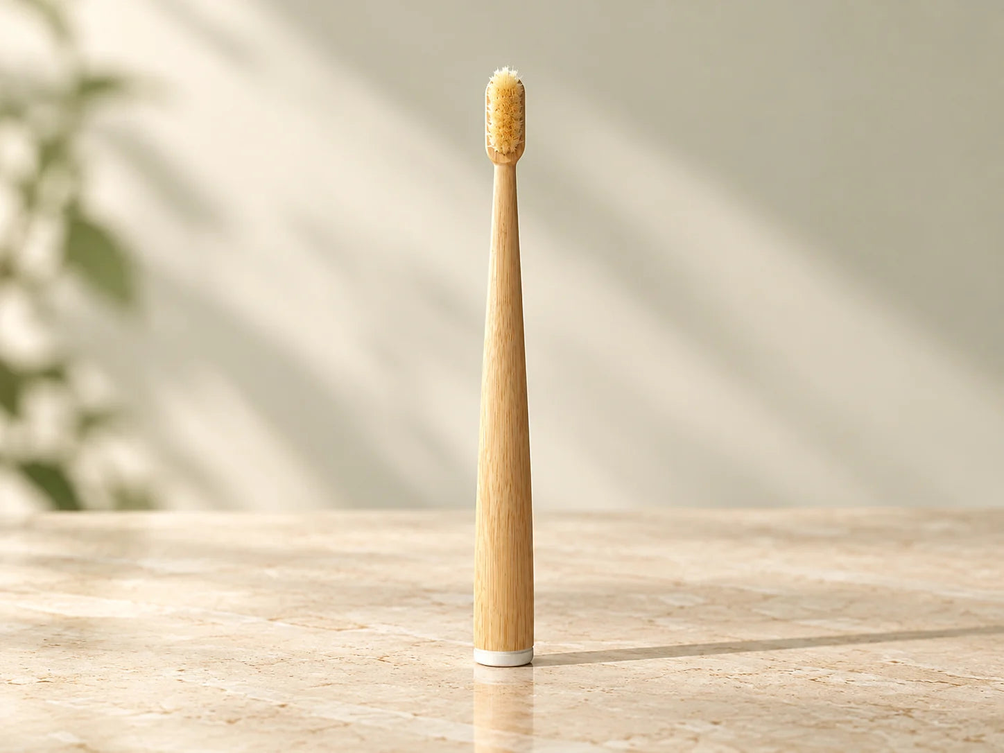 Mumzu bamboo and boar bristle toothbrush standing on warm cream stone